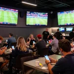 High-energy sports betting scene at https://cakhiatv.design/ showcasing bettors analyzing live match odds.